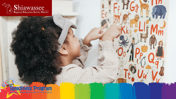 child identifying animals on wall