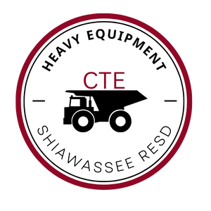 Circle with the words Heavy Equipment and Shiawassee RESD within it.  There is an outline of a dump truck with CTE on top of the truck.