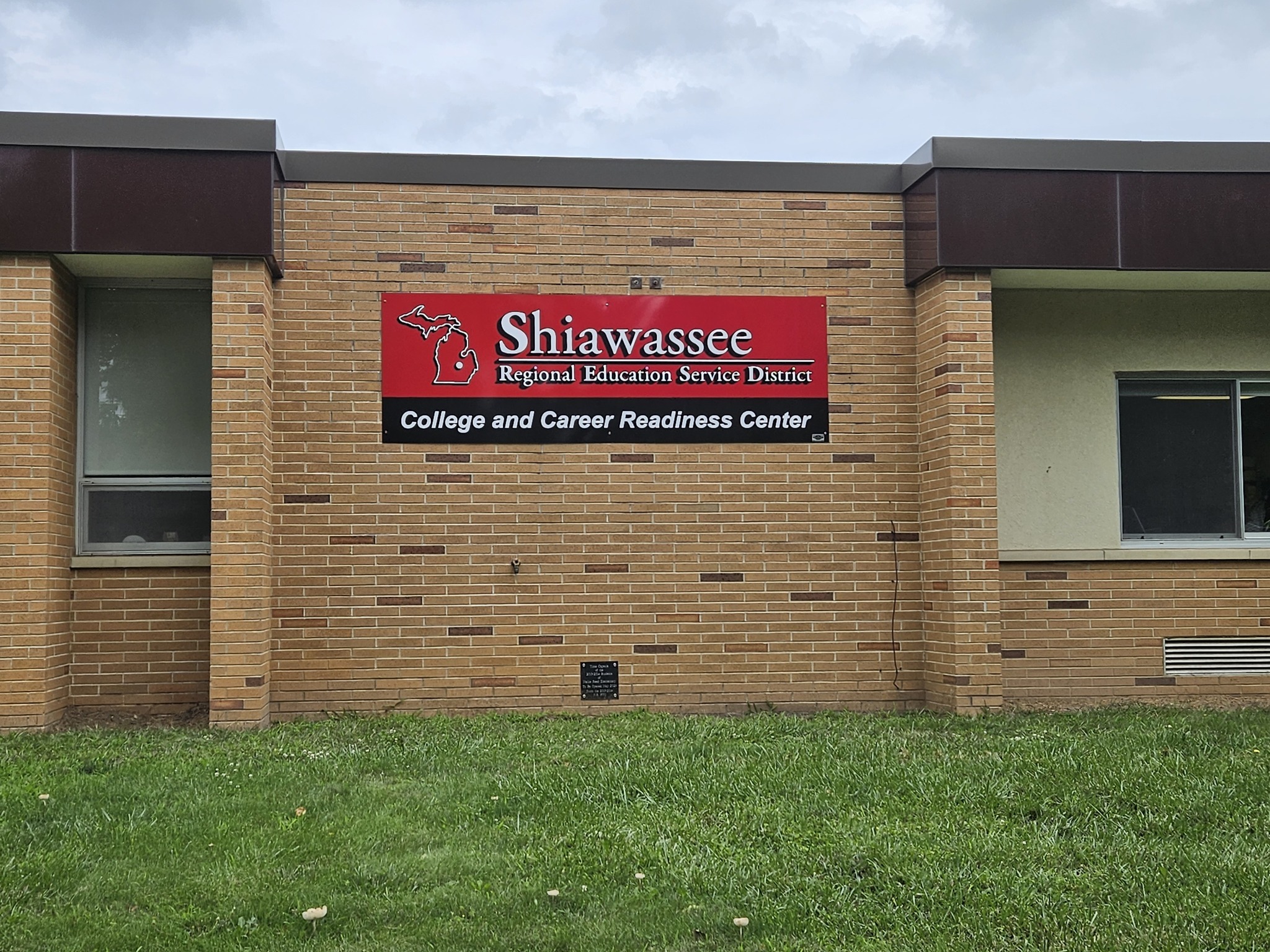 Brick building with red sign.