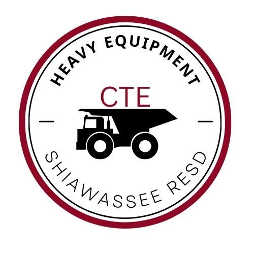 Circle with the words Heavy Equipment and Shiawassee RESD within it.  There is an outline of a dump truck with CTE on top of the truck.